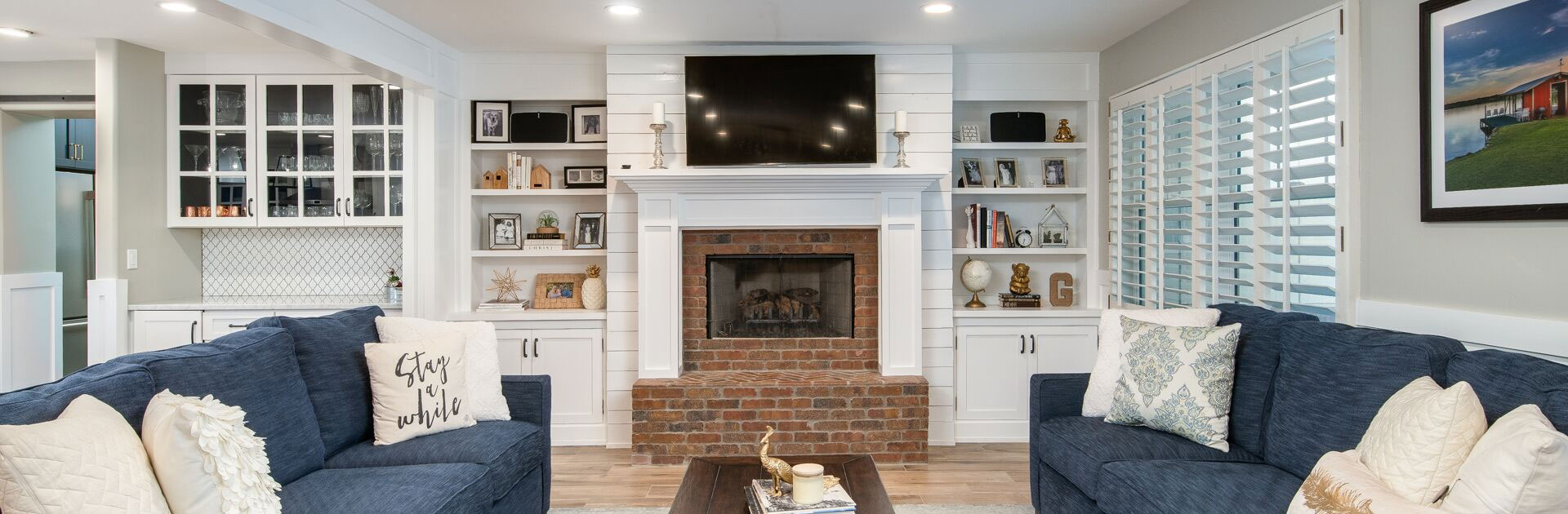 home living room with two couches, a fireplace, and built-in bookshelves
